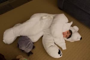 child sleeping on floor in polar bear sleeping bag