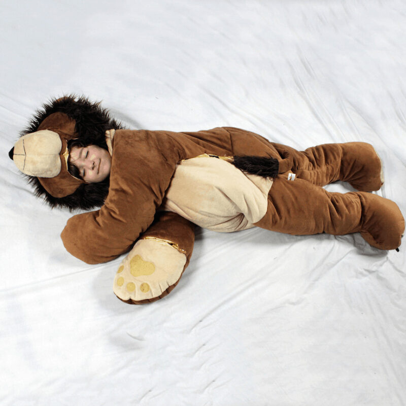 child sleeping in plush lion sleeping bag by snoozzoo