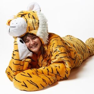 woman laying down in snoozoo plush tiger sleep sack
