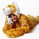 woman laying down in snoozoo plush tiger sleep sack