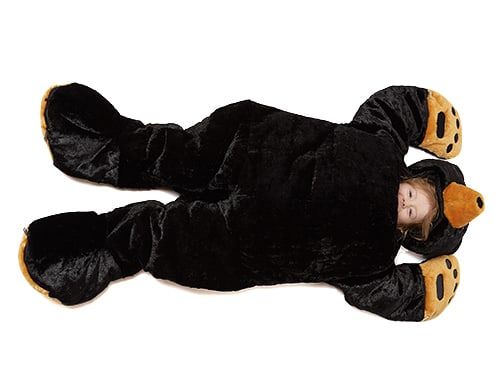 child lounging in stuffed black bear sleep sack by snoozzoo