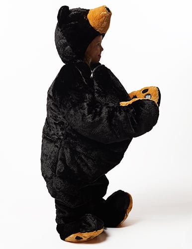 sideview of child wearing snoozzoo black bear sleep sack