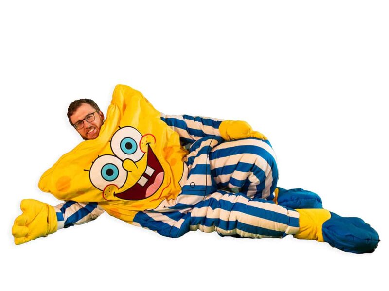 adult laying down in spongebob squarepants sleepsack