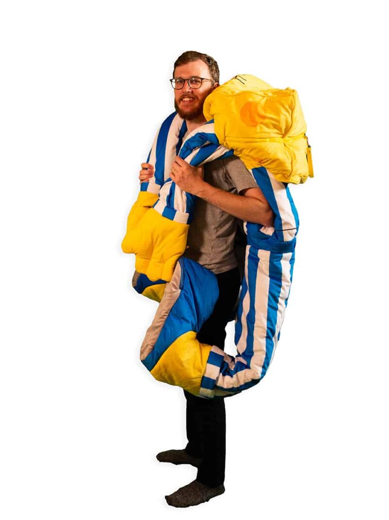 side view of adult using spongebob sleeping bag as blanket